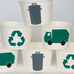 May include: Six white paper cups with different recycling symbols. The cups have green and gray recycling symbols, including a recycling truck and a trash can.