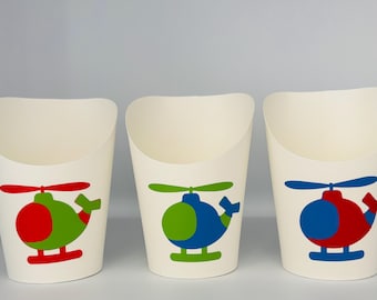 May include: Three white paper cups with a helicopter design. The helicopters are red, green, and blue with green blades.