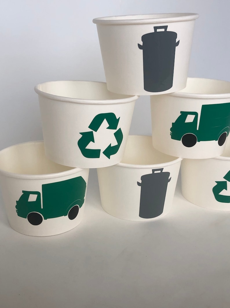 May include: Six white paper cups with green and gray recycling symbols. The symbols include a recycling arrow, a garbage truck, and a trash can.