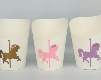 May include: Three white paper cups with a carousel horse design. The horses are gold, pink, and purple with pink bows.
