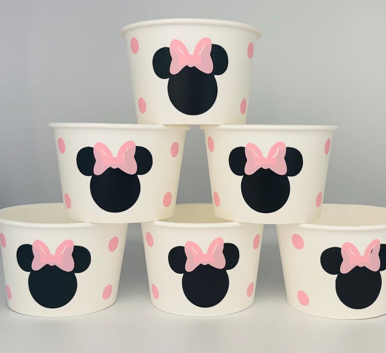Puede incluir: Conjunto de seis vasos de papel blancos con lunares rosas y un dise&ntilde;o de Minnie Mouse negro y rosa.