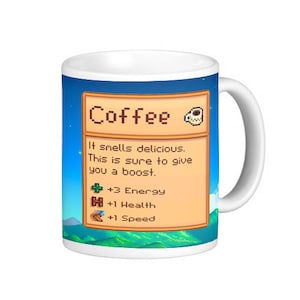 May include: White ceramic mug with a blue and green pixelated design. The mug features a text box with the word "Coffee" and a description of the drink's effects: "It smells delicious. This is sure to give you a boost." The text box also lists the drink's stats: +3 Energy, +1 Health, +1 Speed.