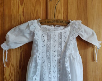 Early 20th century apron fronted waterfall skirted broderie anglaise and lace baby dress