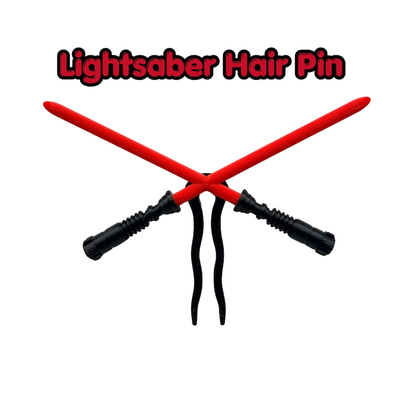 May include: A hair pin featuring two crossed red lightsabers with black handles. The text "Lightsaber Hair Pin" is above the lightsabers in red and black.