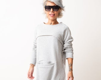 Grey Oversized Sleeveless Jumpsuit Paired with a Top with Long Sleeves