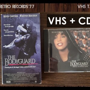 May include: VHS tape and CD of the movie The Bodyguard, featuring Kevin Costner and Whitney Houston. The VHS cover shows a black and white photo of the two actors. The CD cover features a color photo of Whitney Houston.