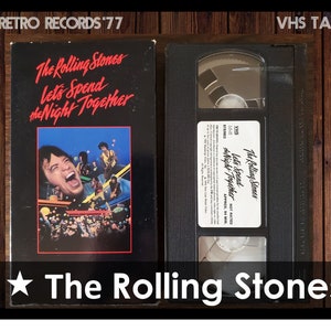 May include: A VHS tape of The Rolling Stones "Let's Spend the Night Together" concert special. The cover features a black and white photo of Mick Jagger singing with a crowd of people in the background.