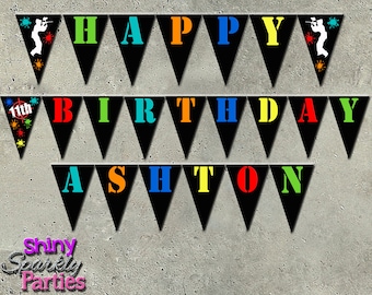 May include: Black triangle pennant banner with the words "Happy 11th Birthday Ashton" in colorful letters. The banner features a paintball player graphic on each end.