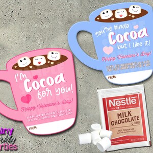 May include: Valentine's Day themed gift set featuring two mug-shaped cards with cocoa and marshmallow designs, and a Nestle Milk Chocolate Hot Cocoa Mix packet. The pink card says "I'm Cocoa for you!" and the blue card says "You're kinda Cocoa but I like it!"