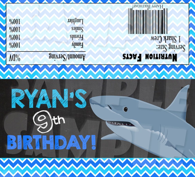May include: A blue and white chevron patterned background with a chalkboard sign that says "Ryan's 9th Birthday!" with a cartoon shark illustration. The sign is on a blue and white chevron patterned background.