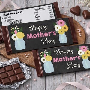 May include: Chocolate bars with "Happy Mother's Day" text and floral designs. One bar is unwrapped, revealing a chocolate block. The bars are surrounded by flowers, ribbons, and heart-shaped chocolates.