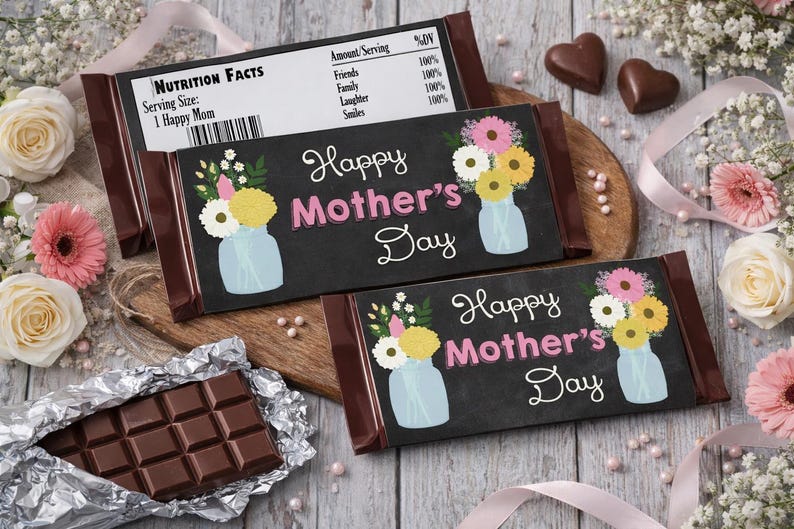 May include: Chocolate bars with "Happy Mother's Day" text and floral designs. One bar is unwrapped, revealing a chocolate block. The bars are surrounded by flowers, ribbons, and heart-shaped chocolates.