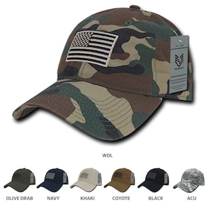 May include: A camouflage baseball cap with a white embroidered American flag on the front. The cap is labeled "WDL" and has a black tag with the text "EST. 2003 BLACK ARMOR" on the side.