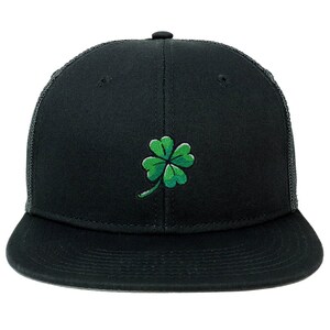May include: A black and green trucker hat with a four-leaf clover embroidered on the front.