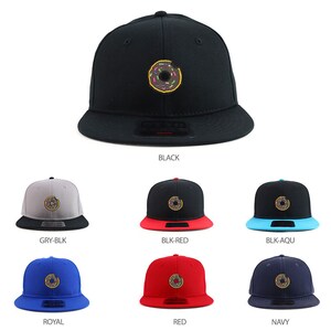 May include: A variety of colorways of a black, flat-brimmed baseball cap with a donut graphic. The cap is available in black, gray and black, black and red, black and aqua, royal blue, red, and navy.