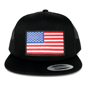 May include: Black trucker hat with a red, white, and blue American flag patch on the front. The hat has a black mesh back and a black snap closure. The hat also has a white sticker on the back that says "The Classic Snapback Yupoong Since 1975."