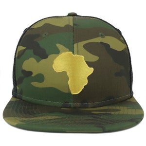 May include: A camouflage trucker hat with a black mesh back and a gold outline of the continent of Africa on the front.