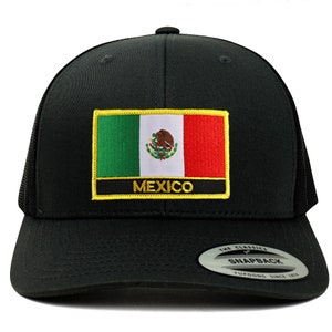 May include: Black trucker hat with a black and gold embroidered patch featuring the Mexican flag and the word "MEXICO". The hat has a black mesh back and a black snap closure.