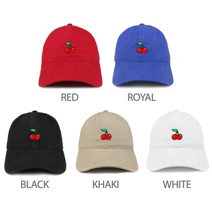 May include: Six baseball caps in different colors with a cherry embroidery on the front. The colors are red, royal blue, black, khaki, and white.