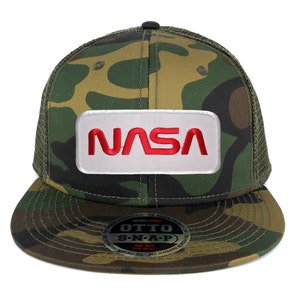 May include: A camouflage trucker hat with a white patch that says "NASA" in red letters. The hat has a black mesh back and a snap closure.