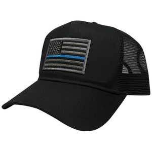 May include: Black trucker hat with a thin blue line American flag patch. The hat has a black mesh back.