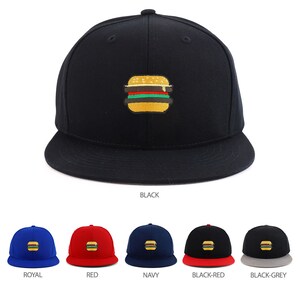 May include: Black flat-brimmed baseball cap with an embroidered burger design. The burger has yellow, green, red, and brown details. Additional caps in royal blue, red, navy, black-red, and black-grey are shown below.