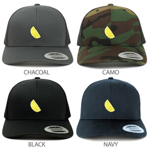 May include: Four trucker hats with a lemon slice embroidered on the front. The hats are in charcoal, camo, black, and navy.