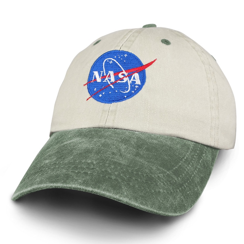May include: A beige and green baseball cap with an embroidered NASA logo in blue, red, and white.