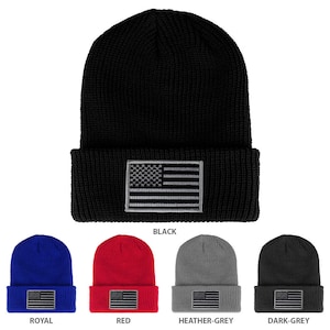 May include: Ten different colour variations of a knitted beanie with a small embroidered American flag on the front. The colours are black, royal blue, red, heather grey, and dark grey.