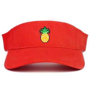 May include: A red visor with a yellow pineapple embroidered on the front.