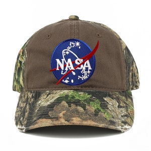 May include: A brown baseball cap with a camouflage pattern on the brim and a blue NASA logo embroidered on the front.
