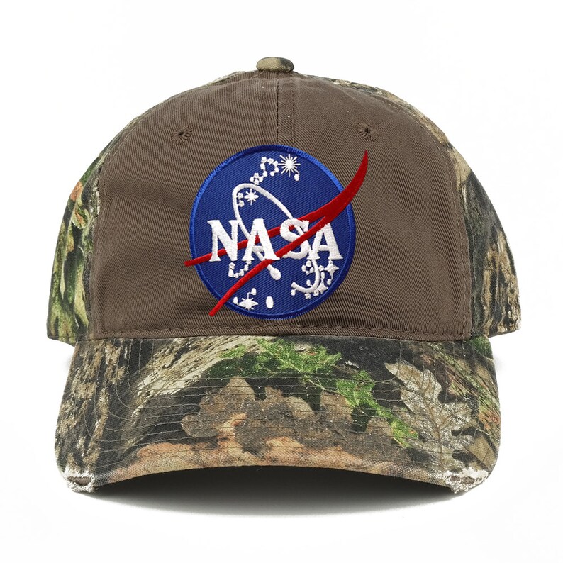 May include: A brown baseball cap with a camouflage pattern on the brim and a blue NASA logo embroidered on the front.