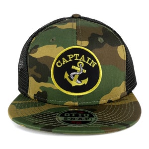 May include: A camouflage trucker hat with a black mesh back. The hat has a black and yellow embroidered patch that says "CAPTAIN" with an anchor inside the circle.