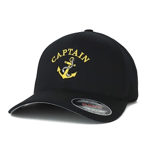 May include: Black baseball cap with a yellow embroidered anchor and the word "CAPTAIN" above it. The cap has a gray brim and a Flexfit logo on the back.