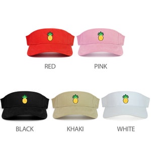 May include: Six visors in different colors with a pineapple design. The colors are red, pink, black, khaki, and white.