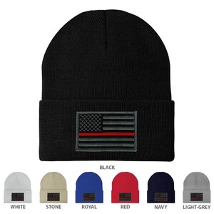 May include: A black beanie with a thin red line American flag embroidered on the front. The beanie is available in 10 colors: white, stone, royal, red, navy, light grey, black, grey, brown, and olive.