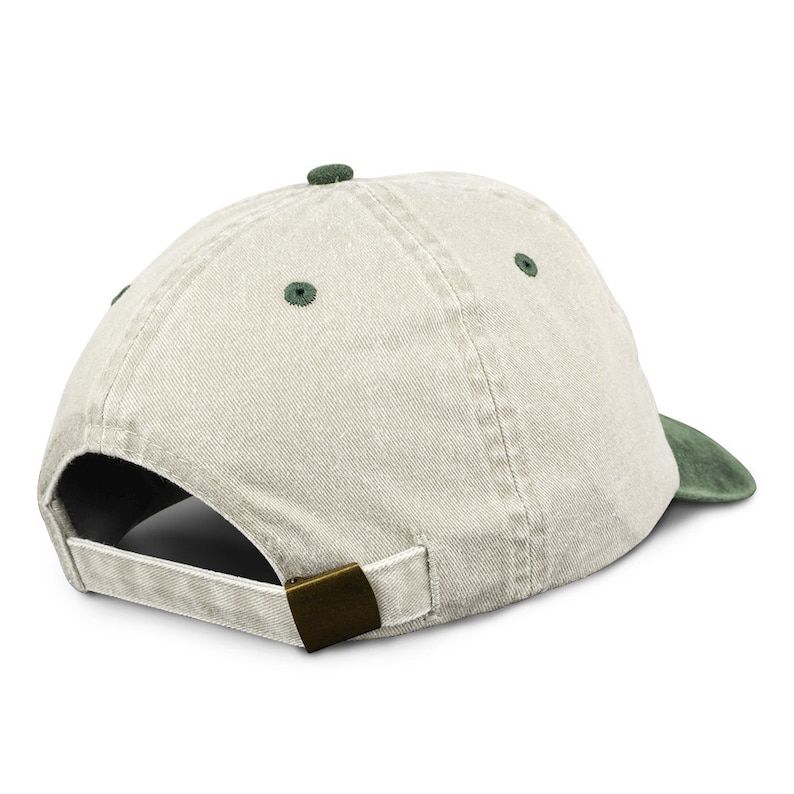 May include: A light beige baseball cap with a dark green underside. The cap has a metal buckle closure.
