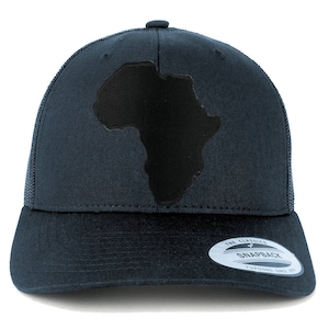 May include: A dark blue trucker hat with a black outline of the continent of Africa on the front. The hat has a mesh back and a black snap closure. The hat also has a white sticker on the back that says "The Classics Snapback Yupoong Since 1974."