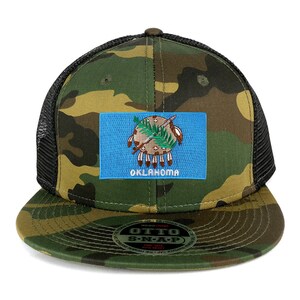 May include: A camouflage trucker hat with a black mesh back. The front of the hat features an embroidered patch of the Oklahoma state flag. The hat has a snap closure and a black "OTTO S-N-A-P" label on the underside of the brim.
