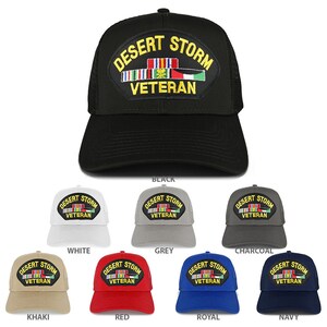 May include: A collection of trucker hats in various colors, each featuring a black patch with the text "DESERT STORM VETERAN" in yellow lettering and a colorful ribbon design. The hats are available in black, white, grey, charcoal, khaki, red, royal blue, and navy.