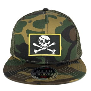 May include: A camouflage trucker hat with a black and white skull and crossbones patch with a yellow border. The hat has a black mesh back and a snap closure. The hat has a label that reads "OTTO S-N-A-P".