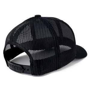 May include: Black mesh trucker hat with a black brim and a black adjustable strap. The hat has a mesh back and a solid front.