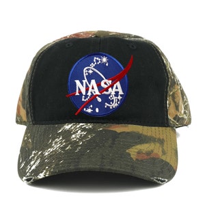 May include: A black baseball cap with a camouflage brim. The front of the cap features a blue and red NASA logo.