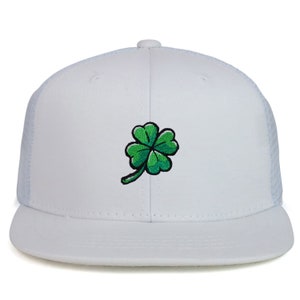 May include: White mesh trucker hat with a green four-leaf clover embroidered on the front.