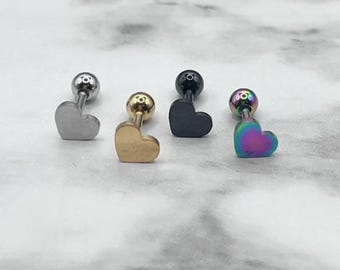 May include: Four heart-shaped stud earrings with different colored metal finishes: silver, gold, black, and iridescent.