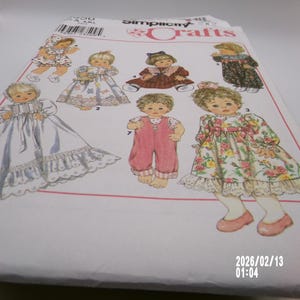 May include: Simplicity Crafts pattern featuring illustrations of baby doll clothing designs. The designs include a christening gown, dresses, and rompers. The pattern is printed on white paper with a variety of colors.