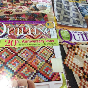 May include: Three different issues of American Patchwork & Quilting magazine. The covers feature colorful quilts with various patterns and designs. The magazine titles are "American Patchwork & Quilting", "Quilting" and "American Quilting".