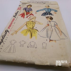 May include: Vintage Simplicity printed sewing pattern envelope. The envelope features illustrations of women's dresses and tops in various styles. The text "Simplicity Details Printed Pattern" is visible, along with the price "35c". The envelope is aged with wear.