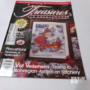 May include: A magazine cover for "Treasures in Needlework" featuring a cross-stitch design of a winter scene with a child, birds, and a Christmas tree. The cover includes text about cross-stitch crafts and Vesterheim.