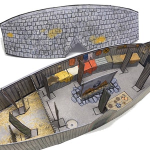 May include: A paper model of a Viking longhouse with a thatched roof. The interior is detailed with furniture, beds, and a fireplace. The model is made of brown cardboard and has a grey stone roof.